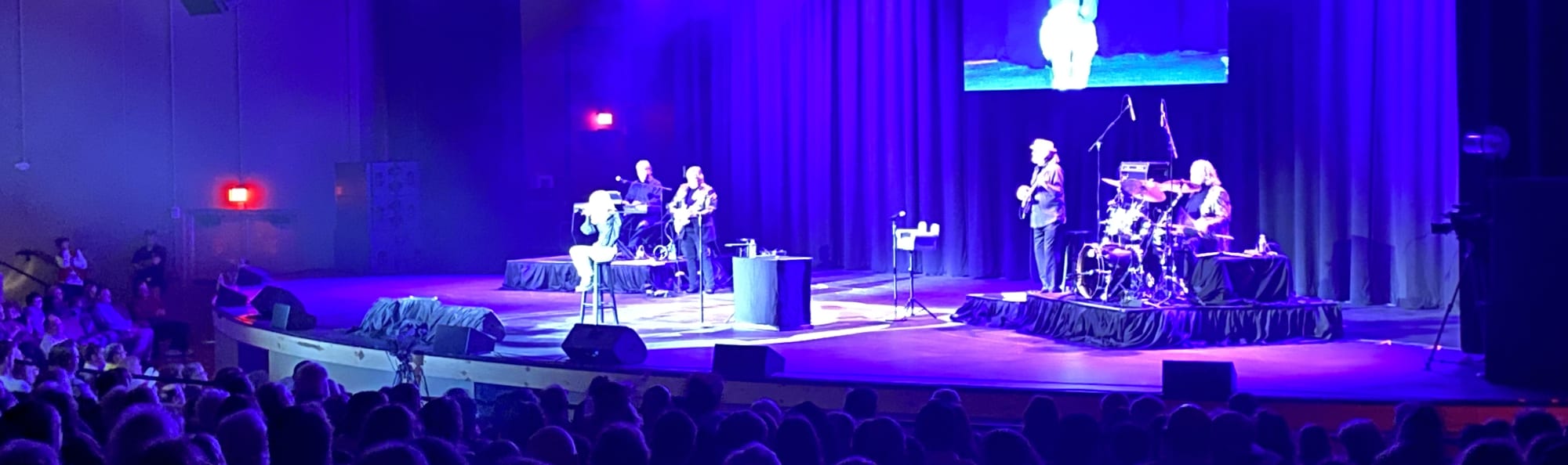 signer on stage in chair washed out by the lights Augusta